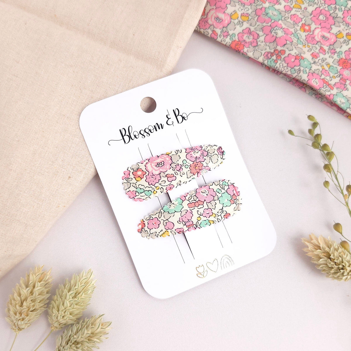 Pair of Liberty Betsy floral snap clips on display card