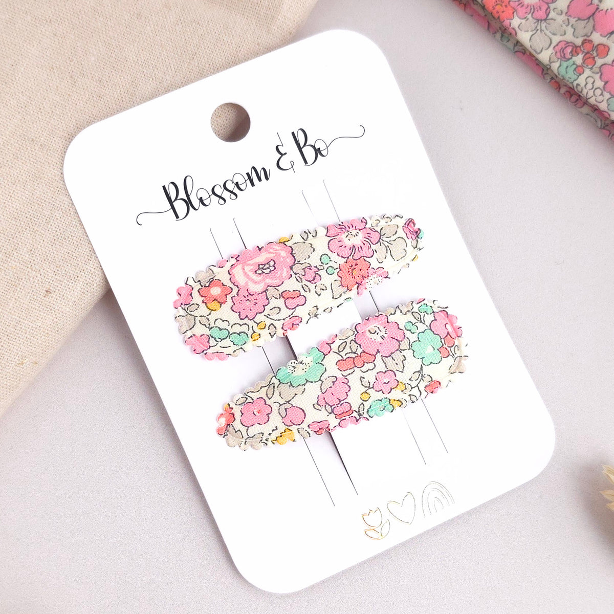 Pair of Liberty Betsy floral fabric snap clips on Blossom & Bo card