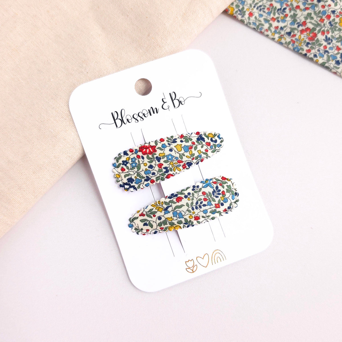 Pair of Liberty floral snap clips for girls on white display card