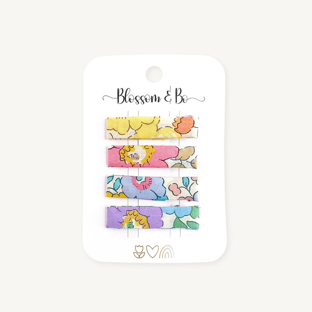 Set of four floral alligator clips for girls on a white branded display card