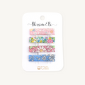 Set of four Liberty floral alligator clips in pink and blue prints on a Blossom & Bo display card