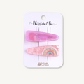 Set of two pink acrylic hair clips featuring a marbled pink clip and a rainbow design on a Blossom & Bo display card.