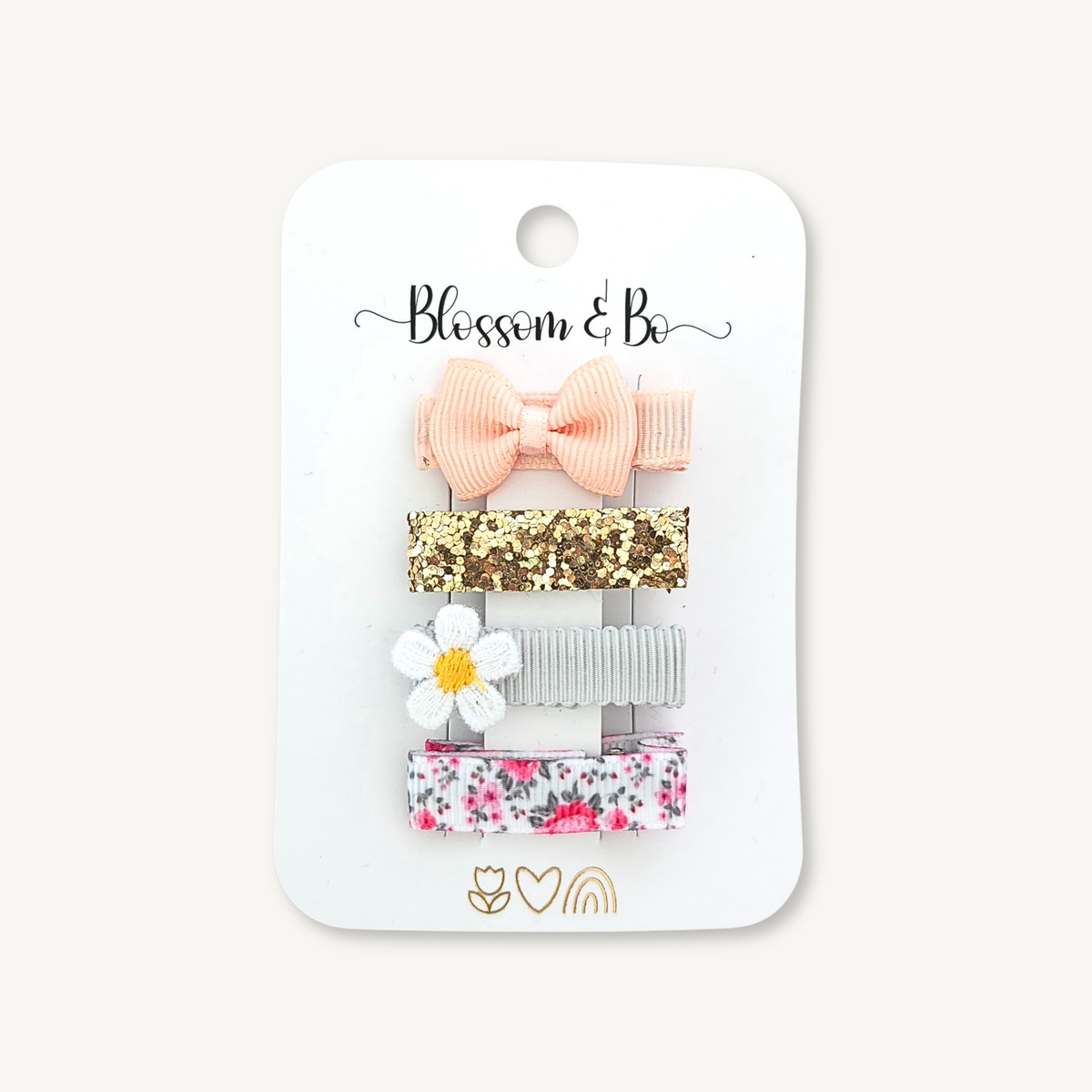 Set of four mini hair clips for girls with pink bow, glitter, daisy and floral design