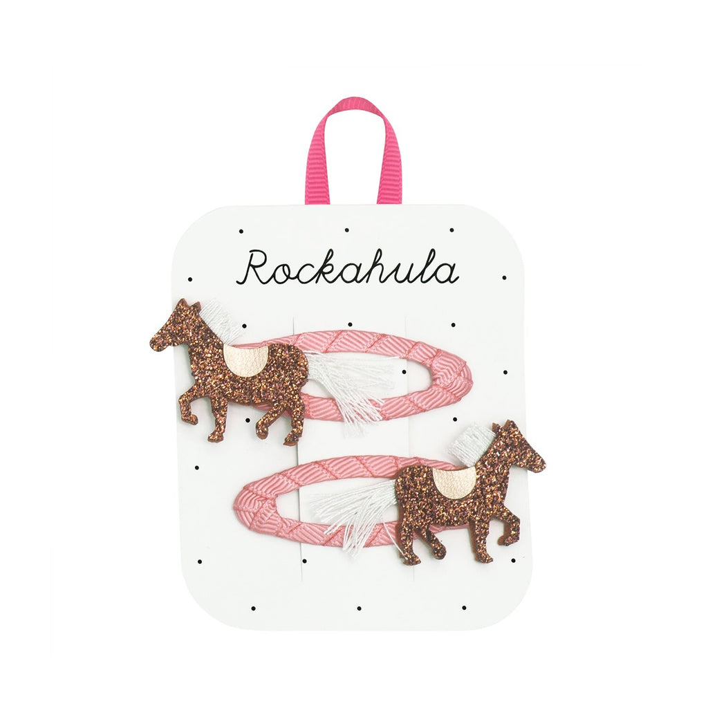 Close up of Rockahula Pippa Pony glitter horse hair clips with pink grosgrain ribbon wrapped snap clips
