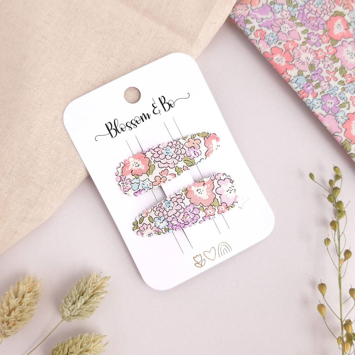 Children's floral snap clips on a branded display card