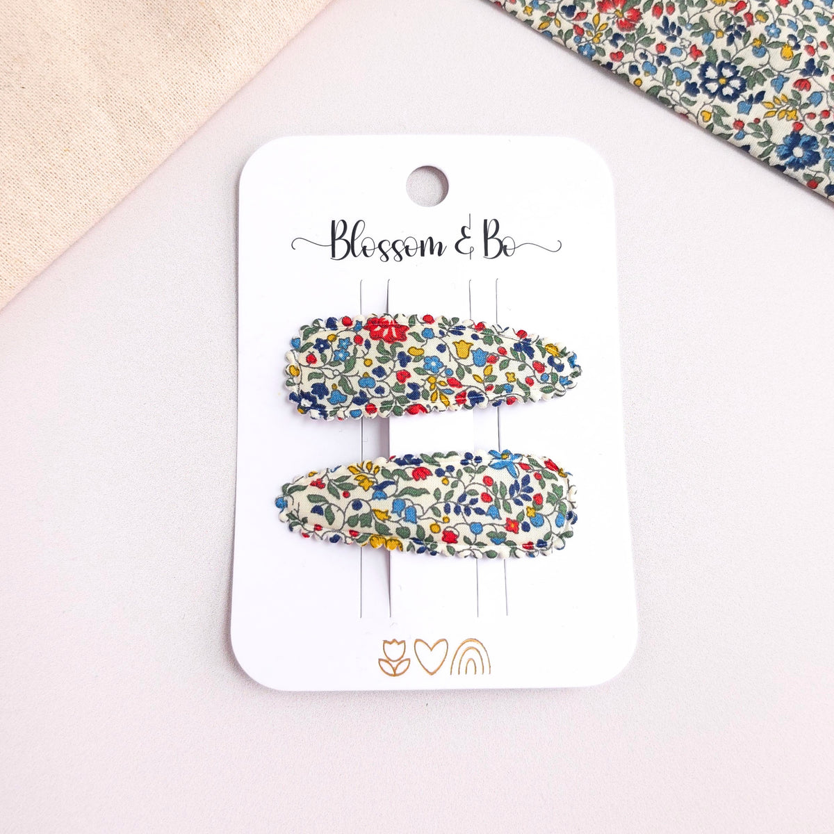 Liberty floral fabric snap clips for girls with floral background