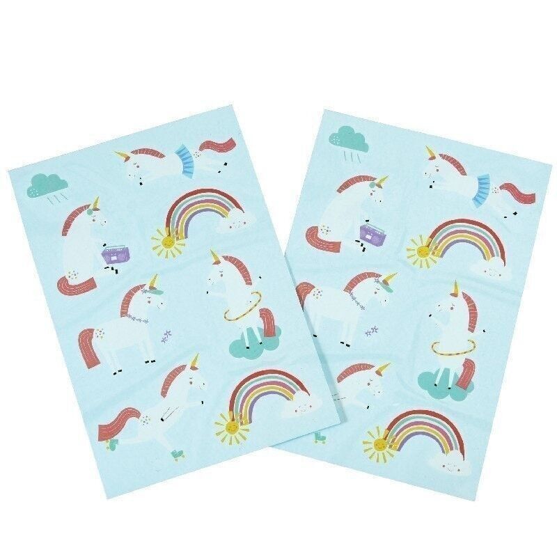 Two sheets of paper with unicorn and rainbow designs on a light blue background