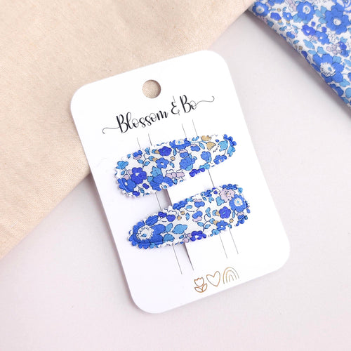 Pair of blue Liberty floral fabric snap clips on Blossom & Bo display card