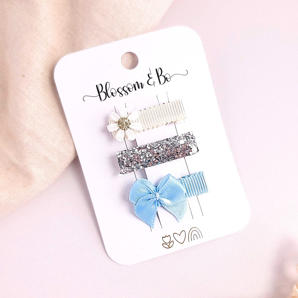 Baby and toddler mini hair clips on a 
Blossom & Bo display card with daisy, glitter and blue bow