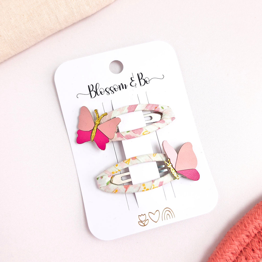 Pir of butterfly hair clips for girls with floral fabric and pink butterfly details