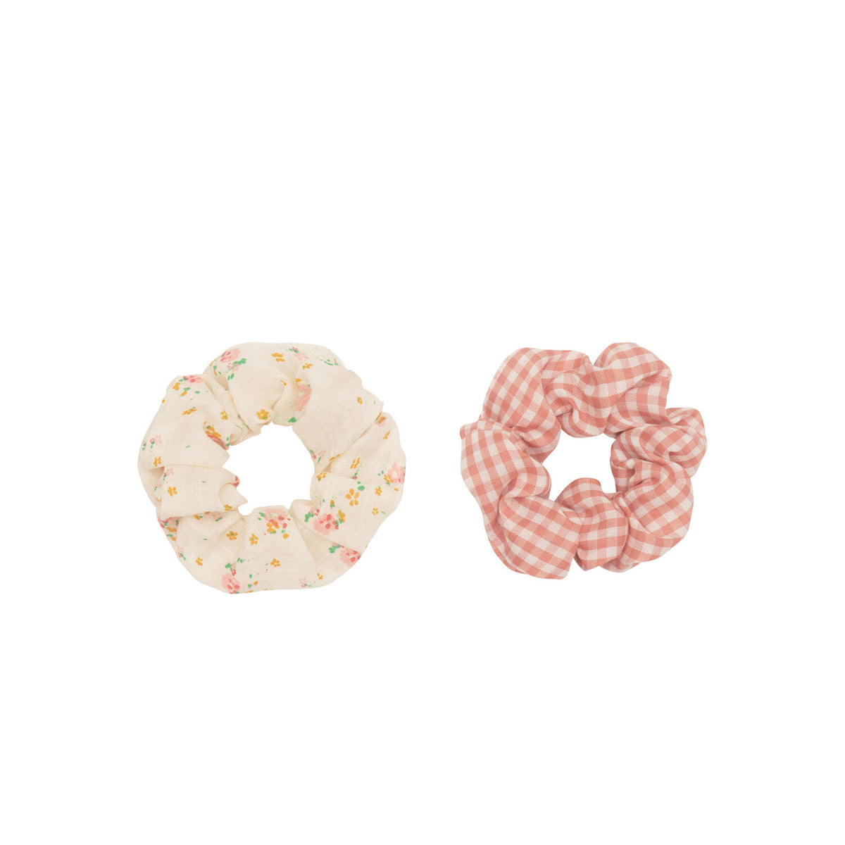 Two scrunchies, one floral and one checkered, on a white background