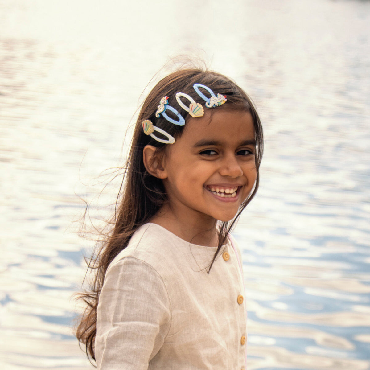Child wearing Rockahula rainbow shell hair clips