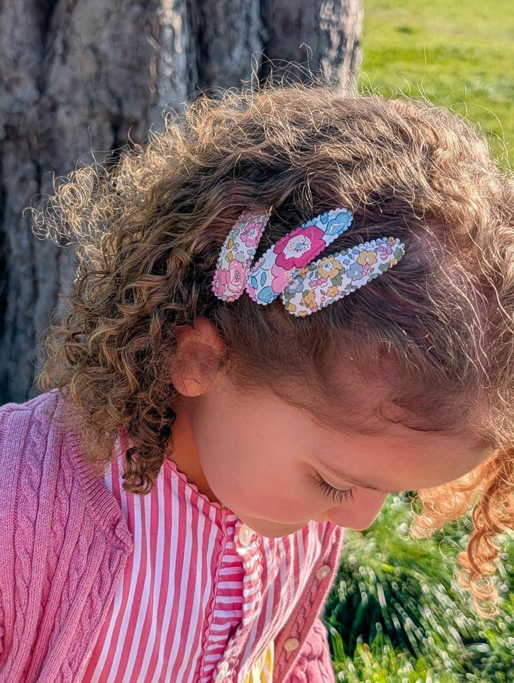 Girl wearing Liberty Betsy floral snap clips in hair