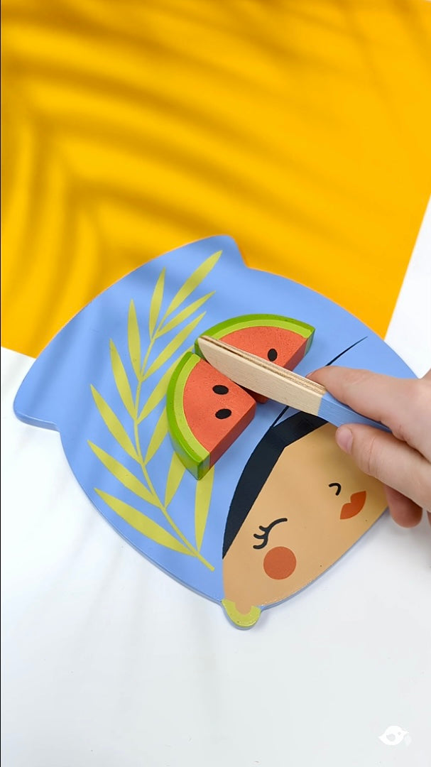 Children's plate with a cartoon character and watermelon slice on a yellow background