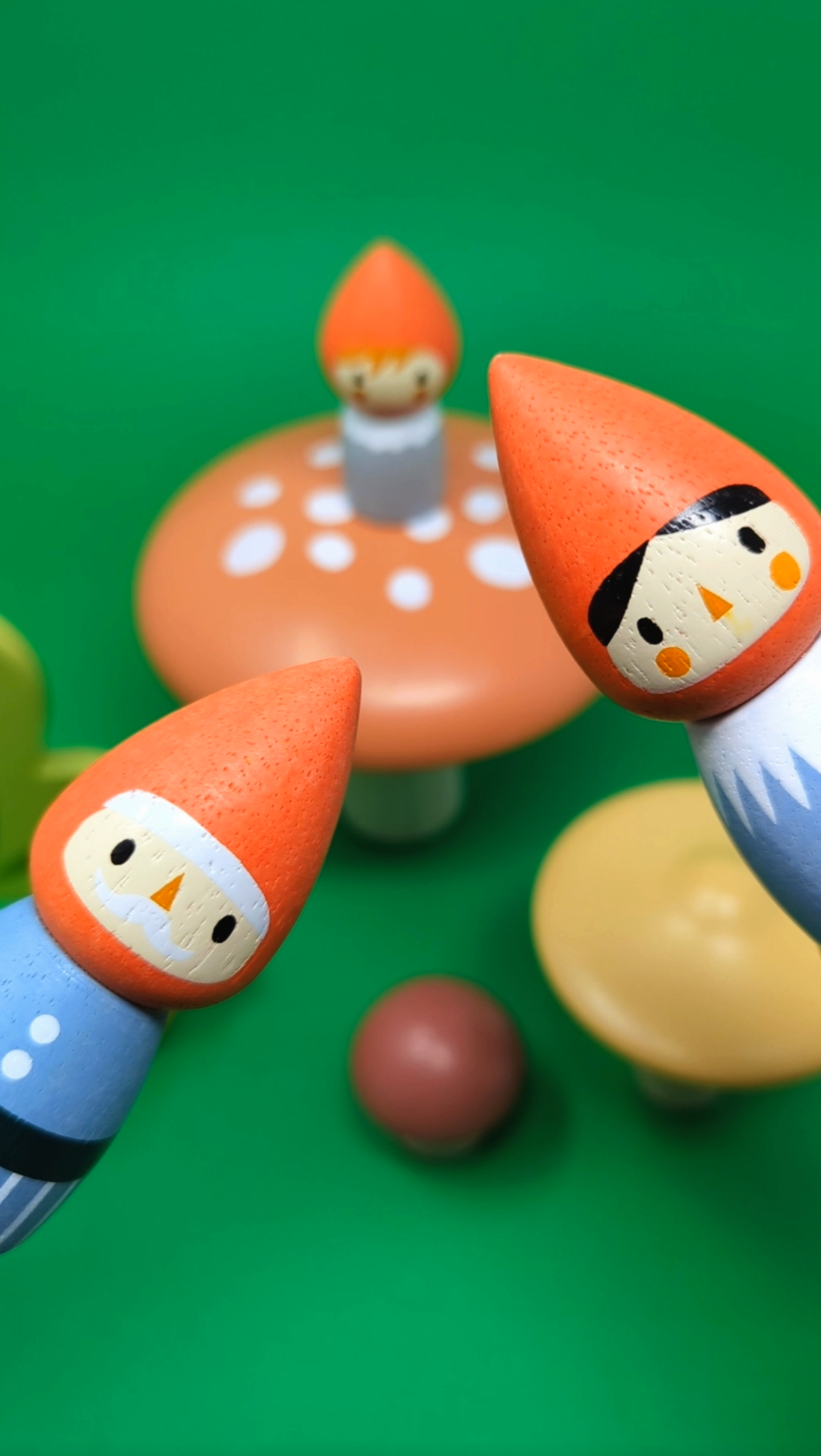 Toy figures with mushroom hats on a green background