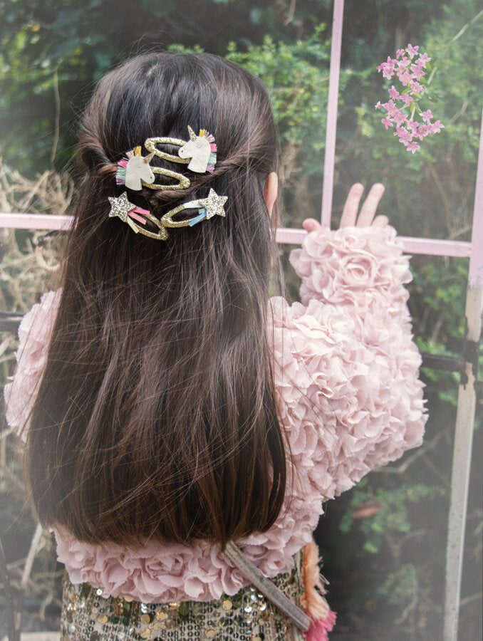 Child wearing Rockahula rainbow unicorn hair clips