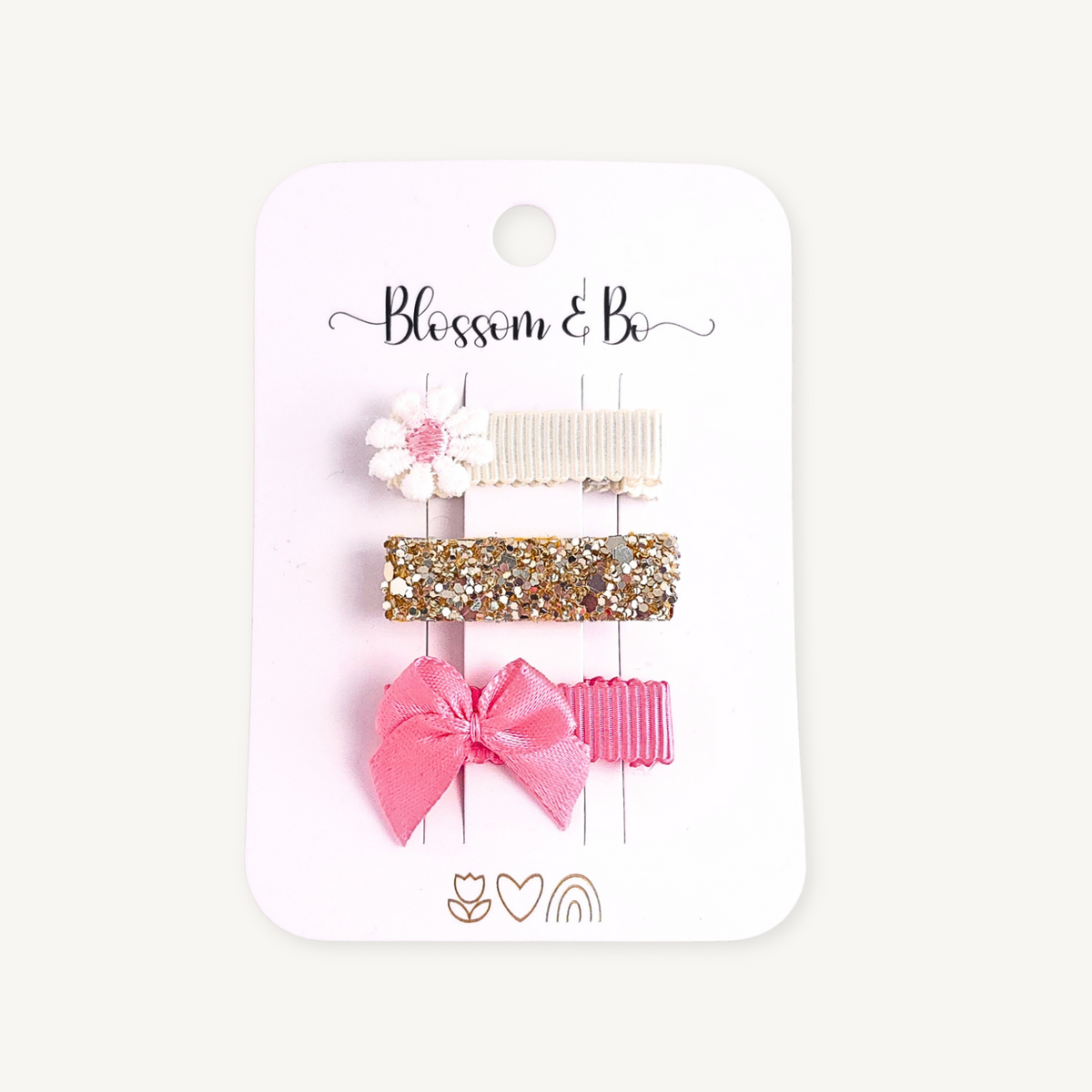 Pink baby and toddler mini hair clip set with embroidered white daisy, gold glitter alligator clip and pink satin bow on a Blossom & Bo display card.