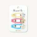 Set of three colourful snap hair clips with glitter stars in pink, blue and yellow, displayed on a Blossom & Bo display card.