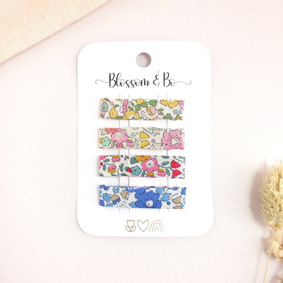 Set of floral hair clips on a 'Blossom & Co' branded card.