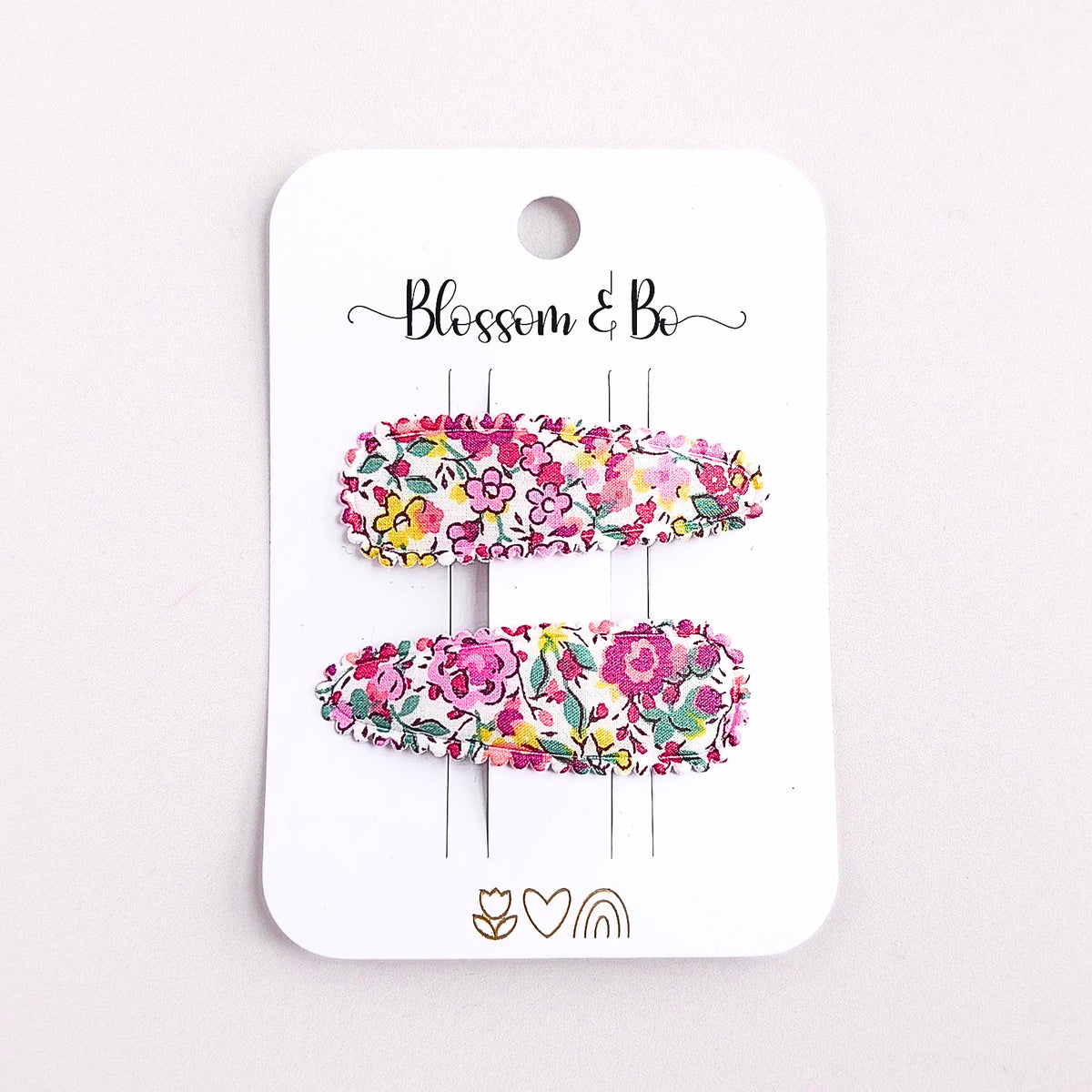 Pink Liberty of London floral fabric snap clips for babies toddlers and girl on a white card