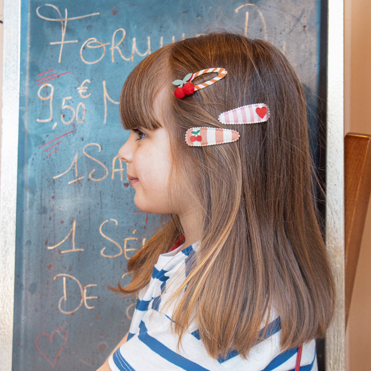 Child wearing Rockahula stripy cherry hair clips