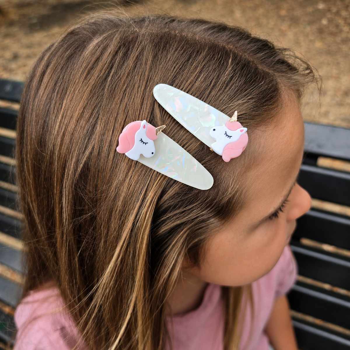 Unicorn hair clips for girls shown in hair with pink manes and pearly clips