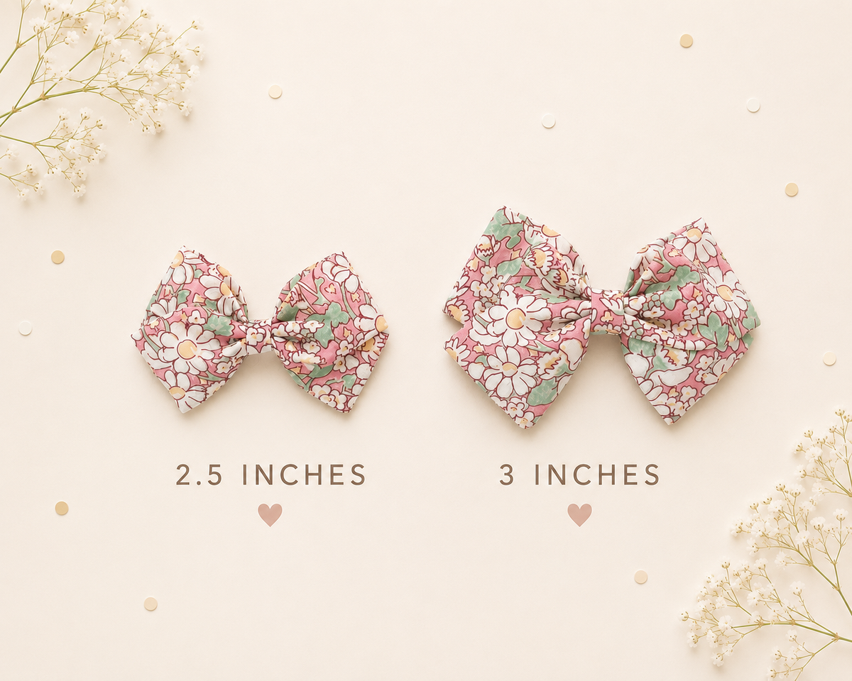 Two floral fabric hair bows shown on a light cream background with decorative flowers and confetti. One bow is labeled 2.