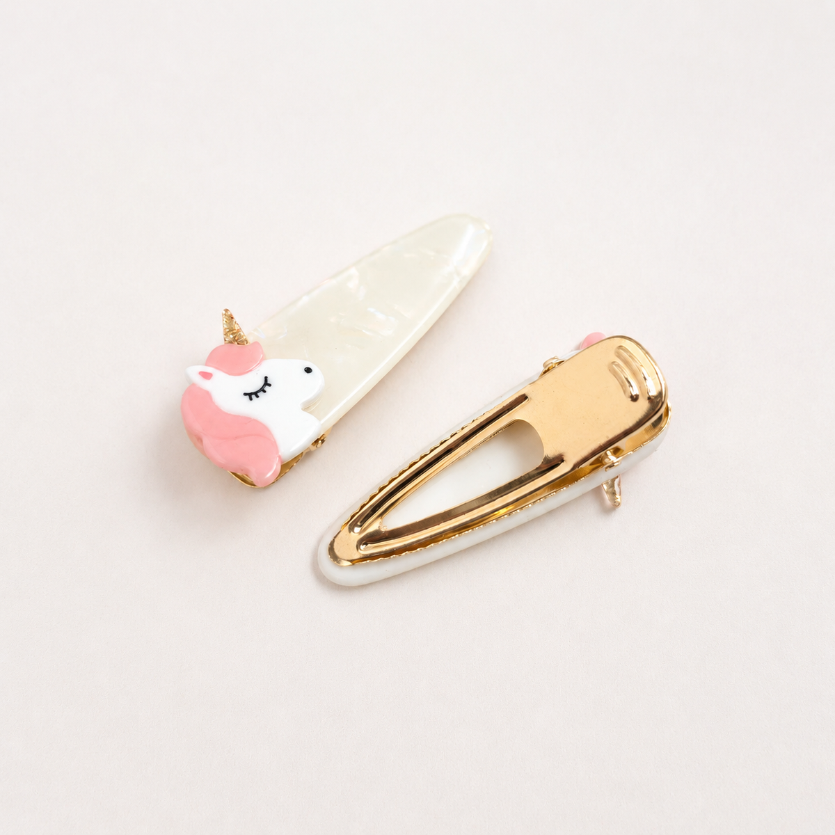 Unicorn hair clip showing gold snap clip fastening and unicorn detail