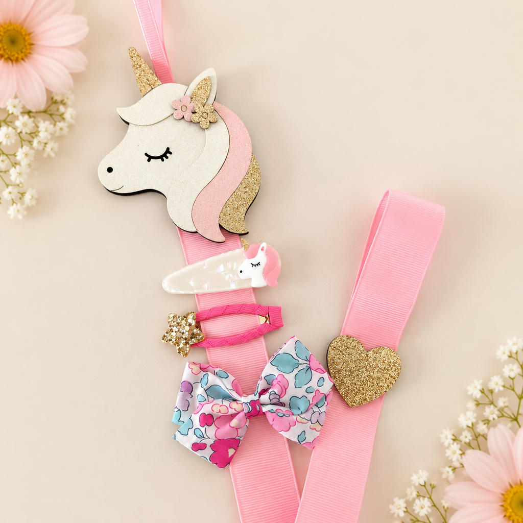 Unicorn hair clip holder with pink ribbon displaying girls' hair clips and bow
