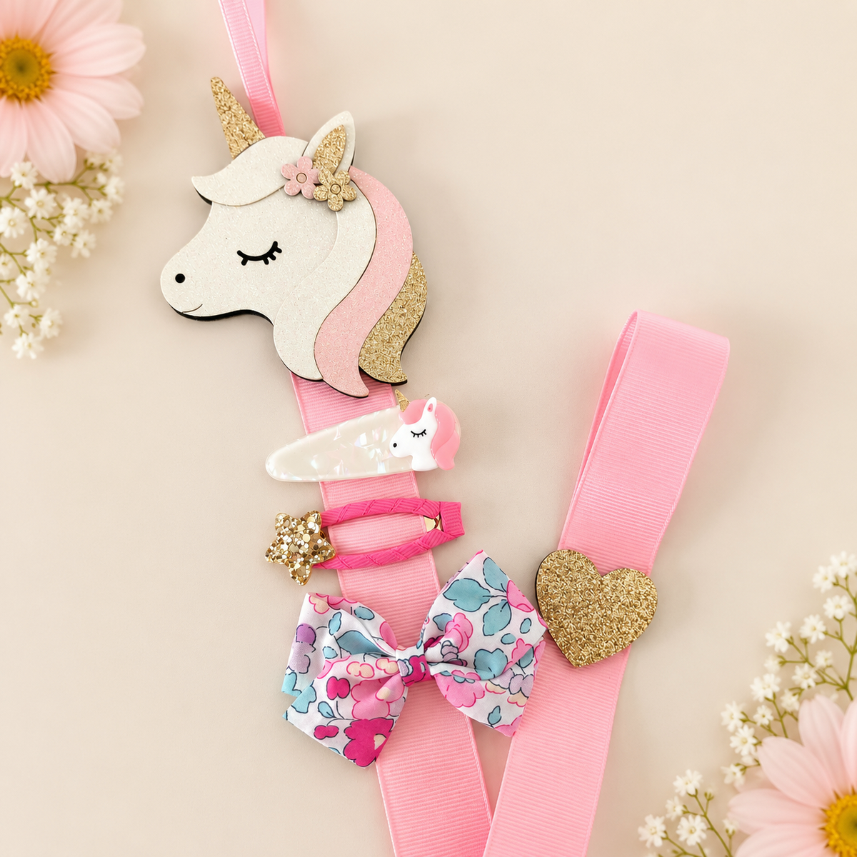 Unicorn hair clip holder with pink ribbon displaying girls' hair clips and bow