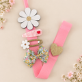 Daisy hair clip holder with pink ribbon displaying girls' hair clips and bows