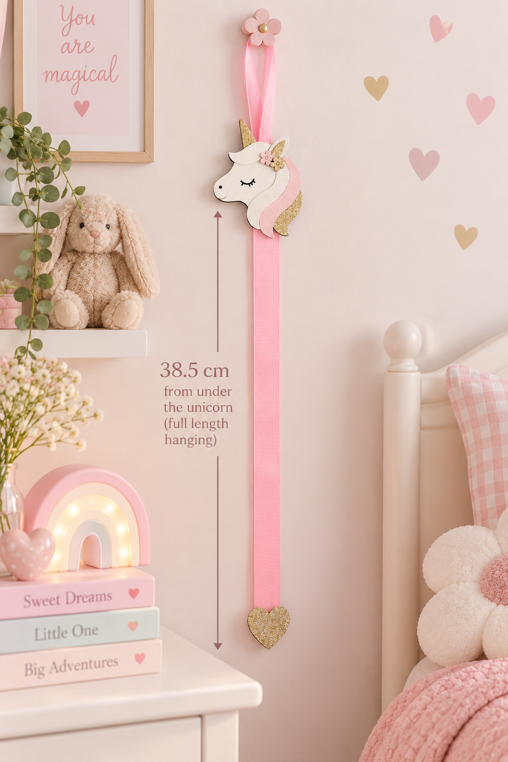 Unicorn hair clip holder with pink ribbon and gold glitter heart detail, shown in a child's bedroom