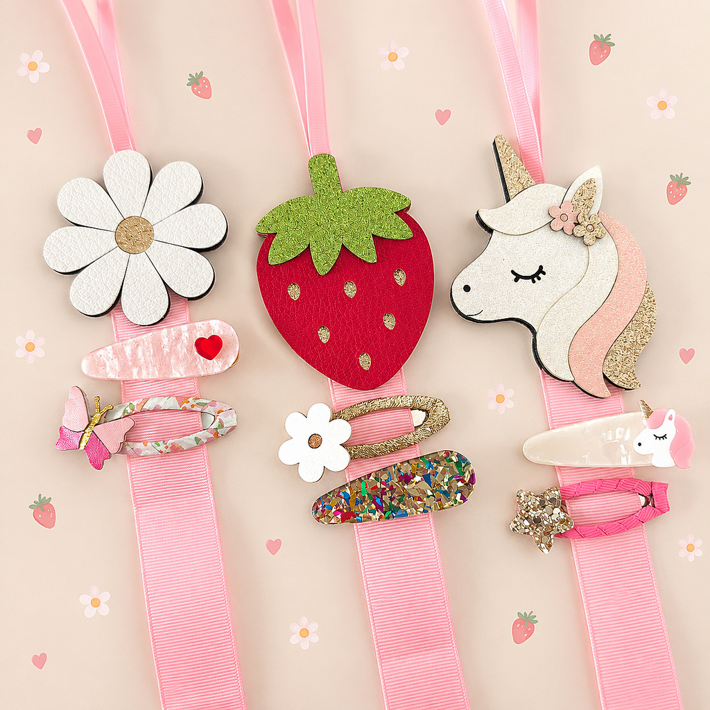 Daisy, strawberry and unicorn hair clip holders displaying colourful hair clips